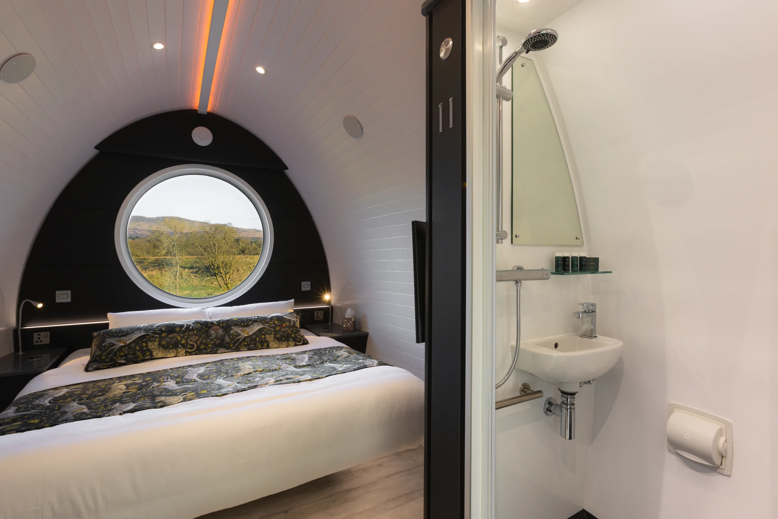 Inside Endrick Escape glamping pods showing bathroom, bed and view from pod window